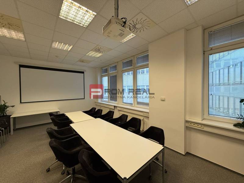 Conference room with a projector and projection screen in the offices.