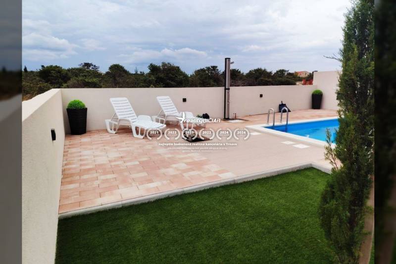 Terrace with loungers and a pool in a family house on Mulo Street in Vrsi.