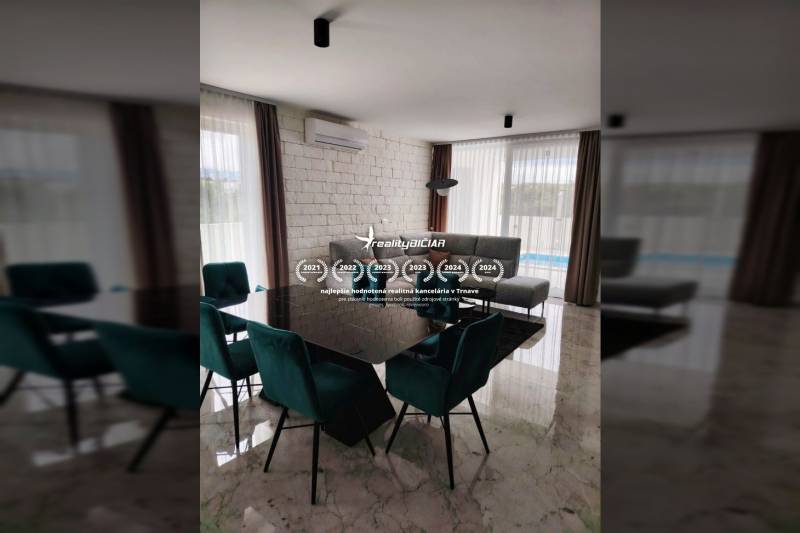 Dining room in a family house with a marble floor, dining table, and gray sofa.