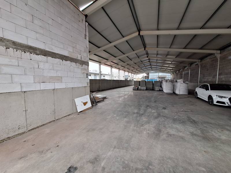 In warehouses and halls, you can see a car, construction materials, and empty space.