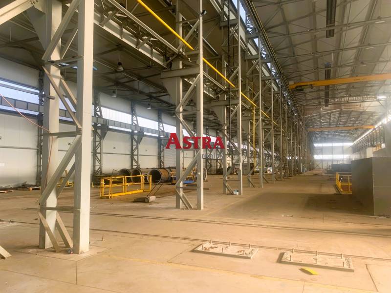 Production facilities with a wide hall, steel structures, and equipment.