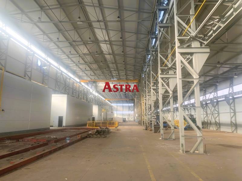 Large manufacturing spaces with high ceilings and steel structures.