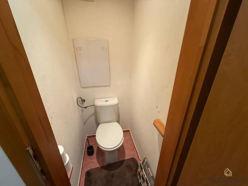 A toilet with a WC bowl and accessories in a 3-room apartment.