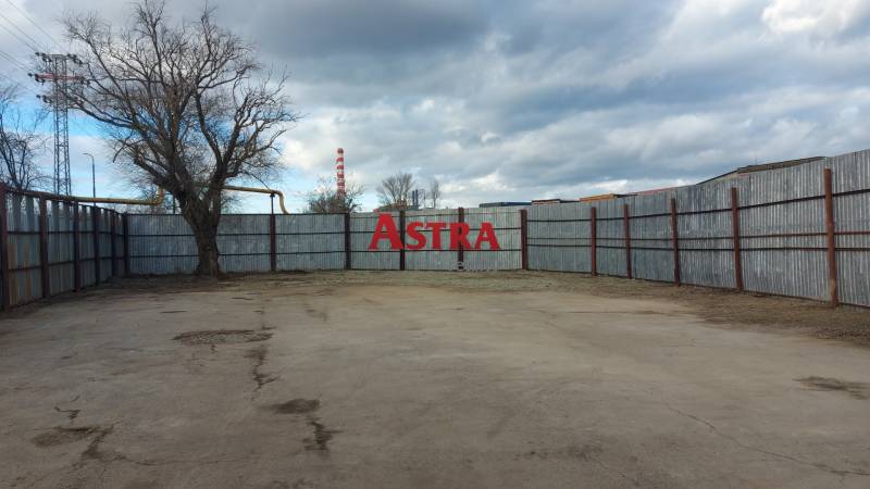 A fenced plot with a concrete surface in Košice, Juh district, suitable for commercial use.
