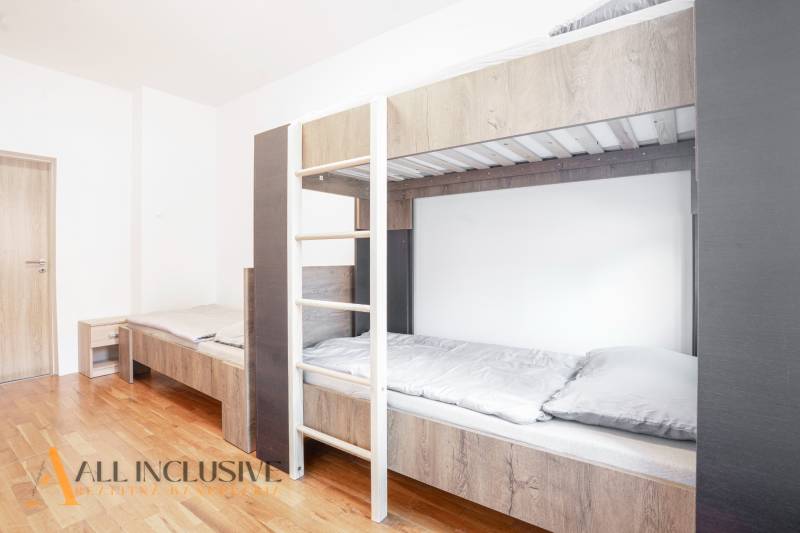 Interior with a bunk bed and wood-patterned flooring in a building.