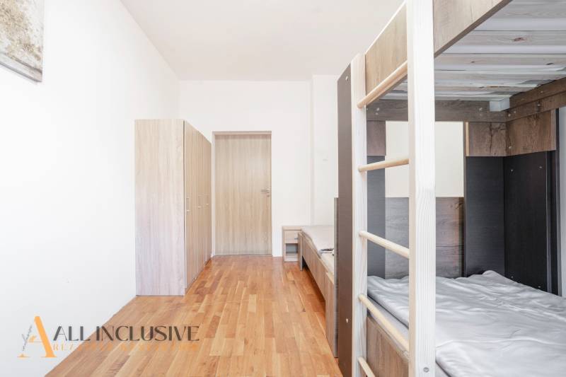 Interior with a bunk bed, wardrobes, and a floor with a wood decor.