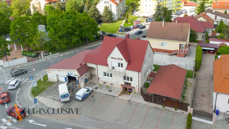 Villa Otto building in Dunajská Streda with a red roof and a parking lot.