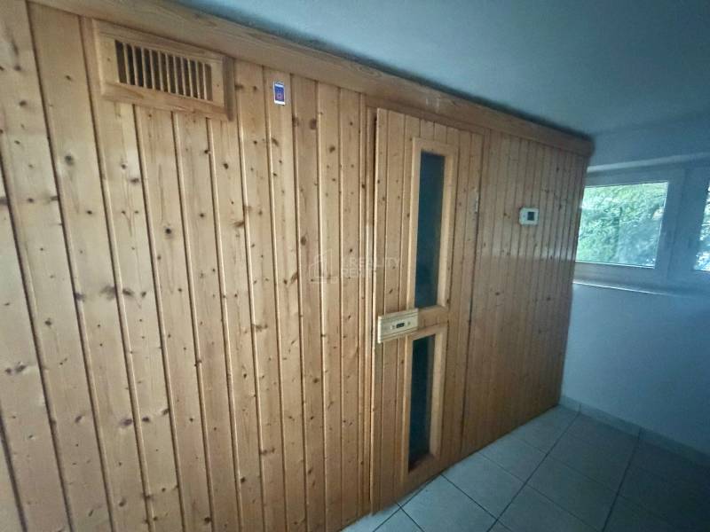 Wooden wall with sauna and tiles in a family house.