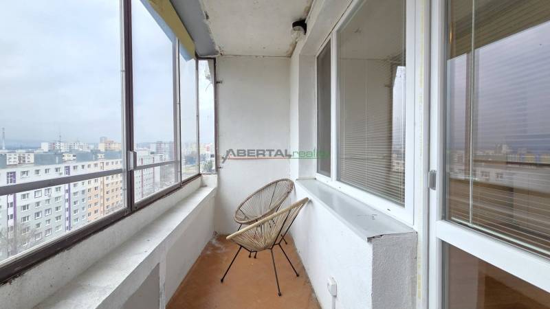 The glazed balcony of the two-room apartment offers a view of Petržalka, Holíčska Street, and the surrounding area.