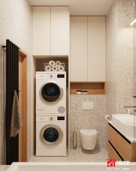 A bathroom in a 4-room apartment with a washing machine, dryer, and modern sink.