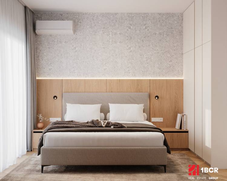 A bedroom with a gray headboard, wood-patterned flooring, and soft lighting in a 4-room apartment.