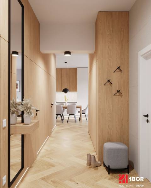 A hallway in a 4-room apartment with a wooden decor floor, leading to the dining room.