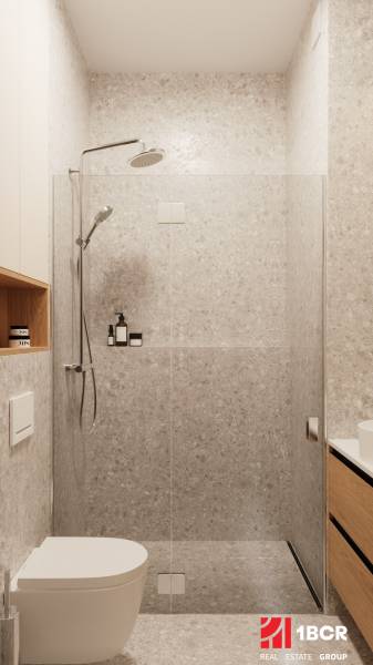 Bathroom of a 4-room apartment with a modern shower and storage spaces.