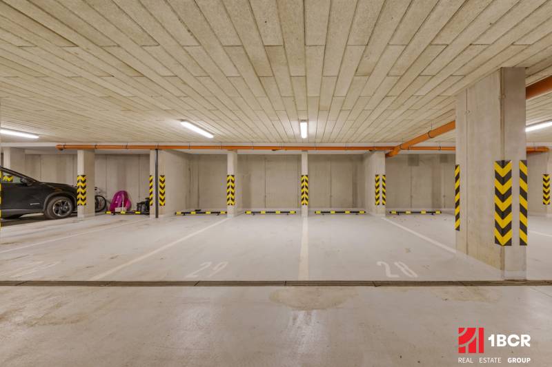 Underground parking spaces with marked pillars in color coding.