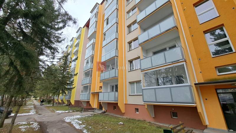 Multi-storey apartment building on Za dráhou Street in Ružomberok with glazed balconies.