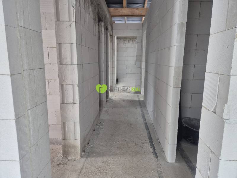 Concrete walls of the structure in the interior of a family house with building material.
