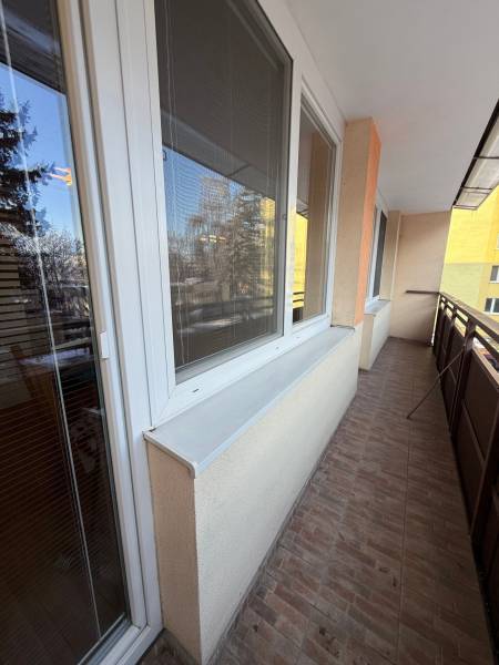 Balcony space in a 3-room apartment with windows and tiles.