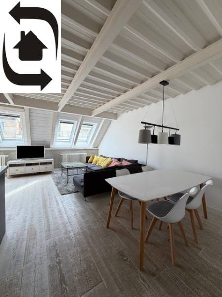 Attic living space in a 4-room apartment with wood-patterned flooring and skylights.
