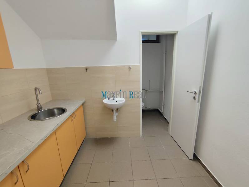 Interior of commercial spaces with a sink and a kitchen unit with a basin.