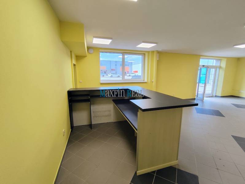 Bright commercial space with a counter and tiled floor.