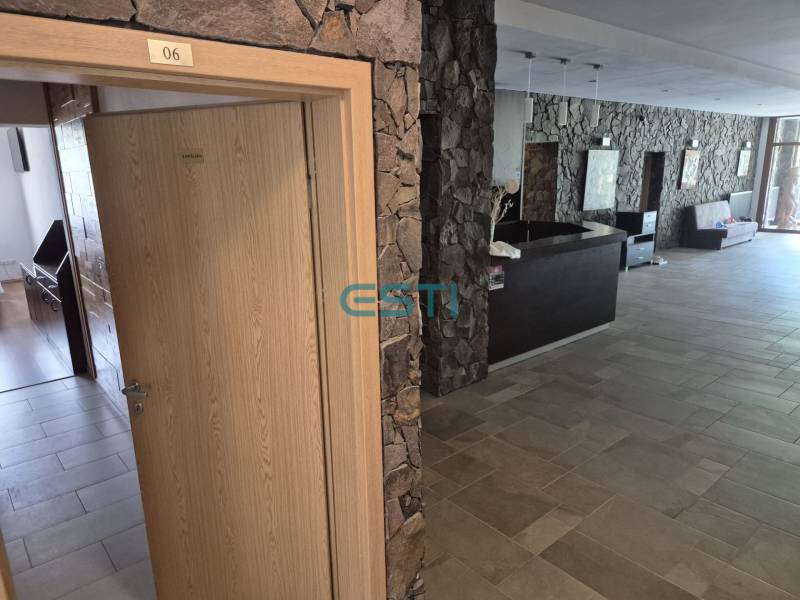 Stone walls and wooden doors leading to an office in a one-room apartment.