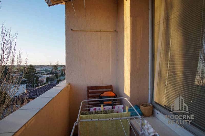 A balcony with a view of the city, a clothes drying rack, typical for a 3-room apartment in Nové Zámky.