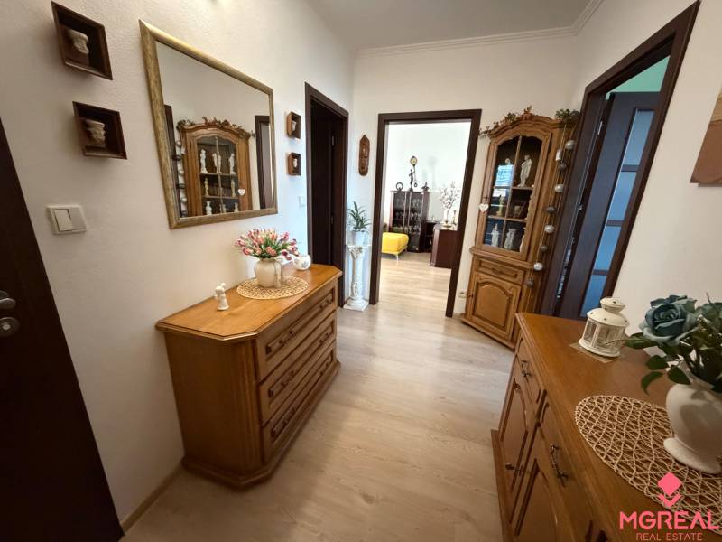 Interior of a 3-room apartment with wardrobes, decorations, and flooring with a wooden decor.