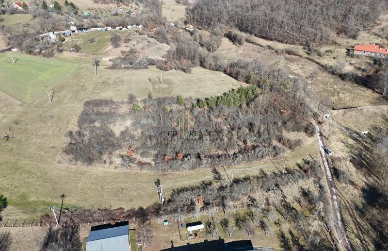 Aerial view of extensive residential lands in Krupina, with forests and fields.