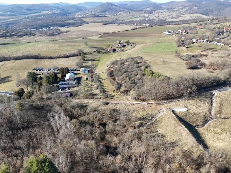 Aerial view of plots - housing in Krupina surrounded by hills and nature.