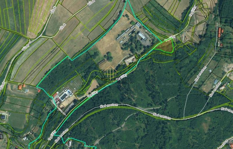 Aerial view of plots - housing around Krupina with visible roads and parcels.