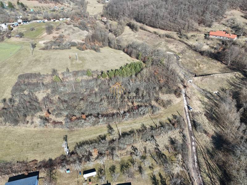 Aerial view of residential plots in Krupina, surrounded by nature and trees.