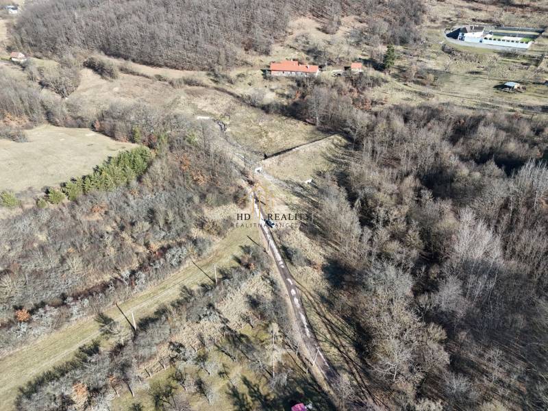 Plots - housing in Krupina near the forest with a rural landscape and grassy areas.