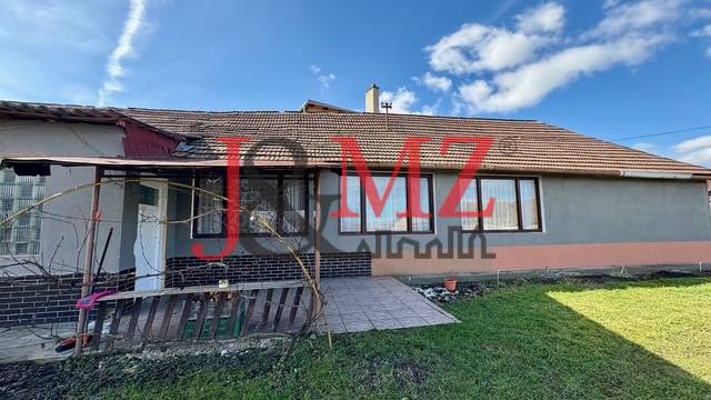A family house in Mýtne Ludany with a yard, terrace, and gray facade.