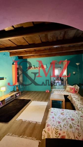 A room in a family house with a wooden decor floor and comfortable sofas.