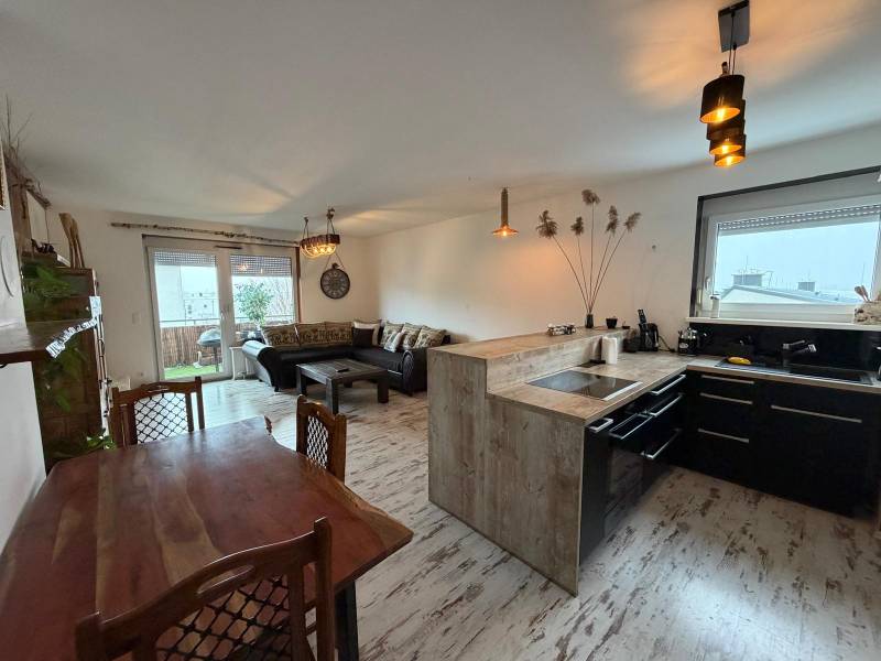 Living room with a kitchen in a 3-room apartment, floor with a wooden decor.