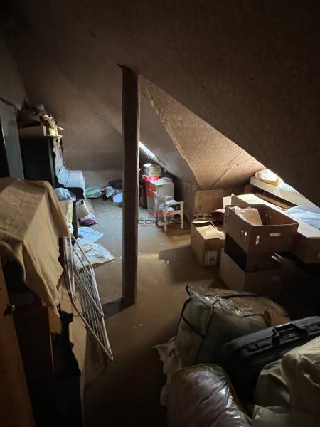 Attic room in a family house full of boxes and stored items.
