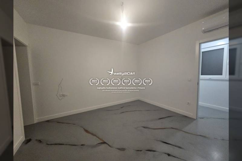 An empty room in a villa with concrete floor decor and white walls.