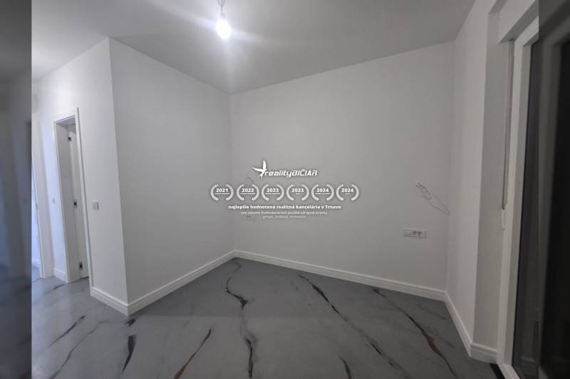 An empty room in a villa with white walls and a marble-patterned floor.