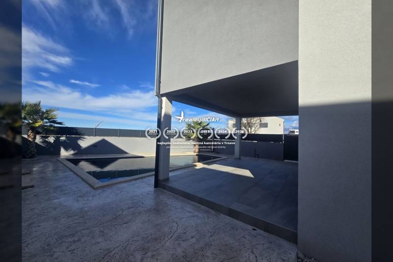 Villa on Zukve Street, Vrsi, with a terrace and a pool surrounded by palm trees.