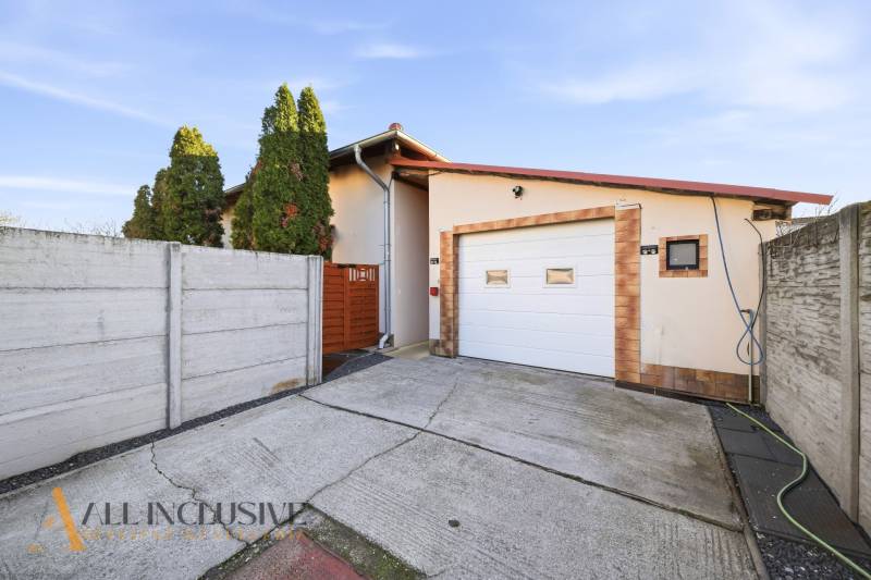 A family house in Hviezdoslavov with a garage, enclosed by a fence, concrete driveway.