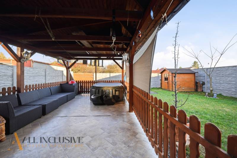Covered terrace with a sofa and hot tub, garden shelter in a family house in Hviezdoslavov.