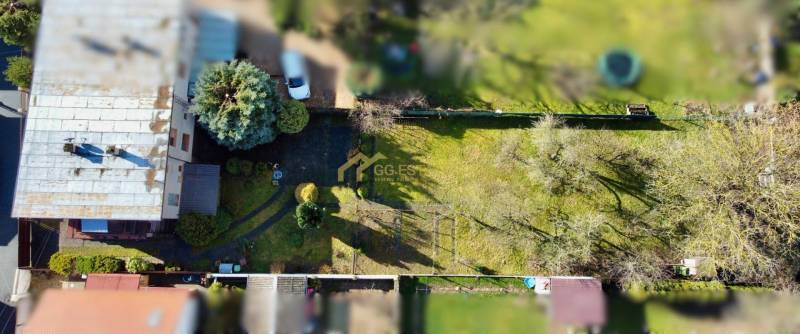 A family house on Kalinčiak Street in Michalovce with an extensive lawn and trees.