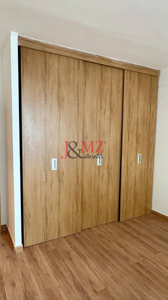 A wardrobe with sliding doors and a floor with a wooden decor in a 2-room apartment.