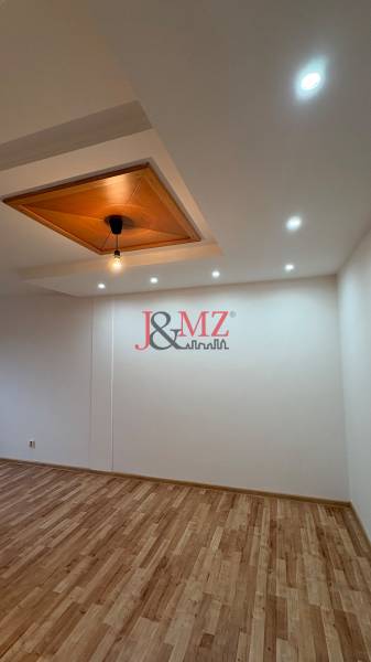 Ceiling lamp and floor with wood decor in a 2-room apartment.