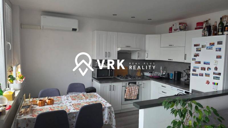 A kitchen in a 3-room apartment with a corner kitchen unit and air conditioning.