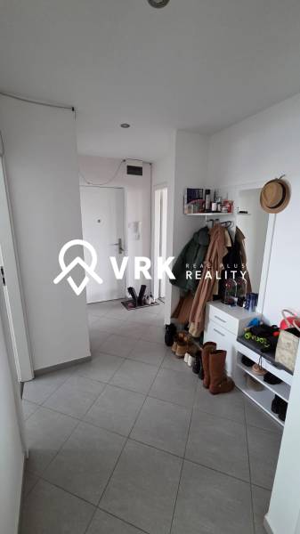 A hallway in a 3-room apartment with tiles, a shoe cabinet, a mirror, and a coat rack.