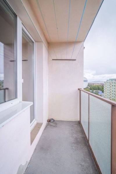 The balcony of a 2-room apartment in Poprad with a view of the housing estate and panel buildings.