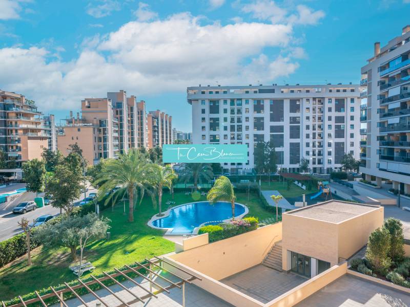 View of residential buildings and a pool in Alicante, 2-bedroom apartment.