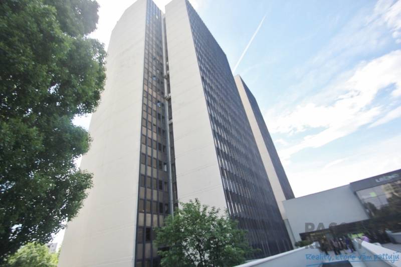 High-rise office building on Kutlíkova Street in Bratislava - Lúky, partially surrounded by greenery.