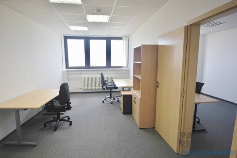 Offices with office furniture, gray carpet, and a light wall, ready for work.